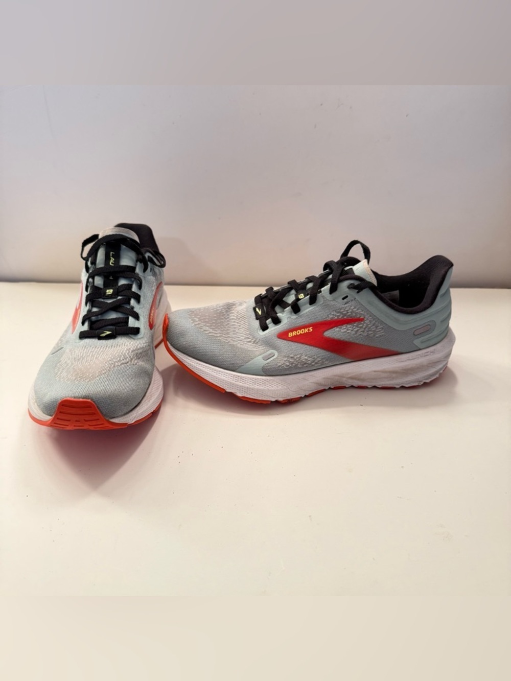 Brooks Light Gray Running Shoes with Red and Orange Accents